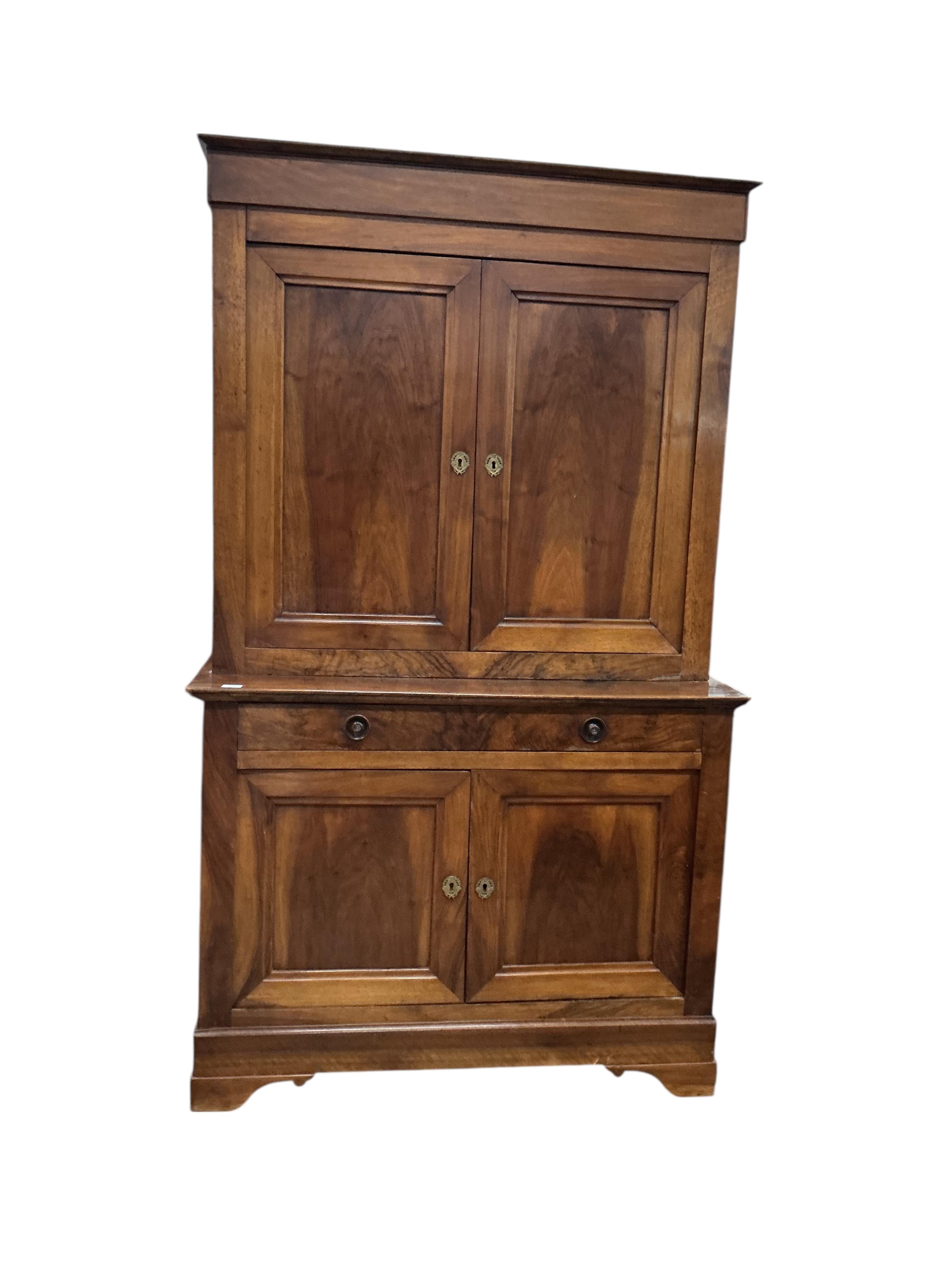 A 19th century French Biedermeier walnut side cabinet, width 125cm, depth 58cm, height 214cm